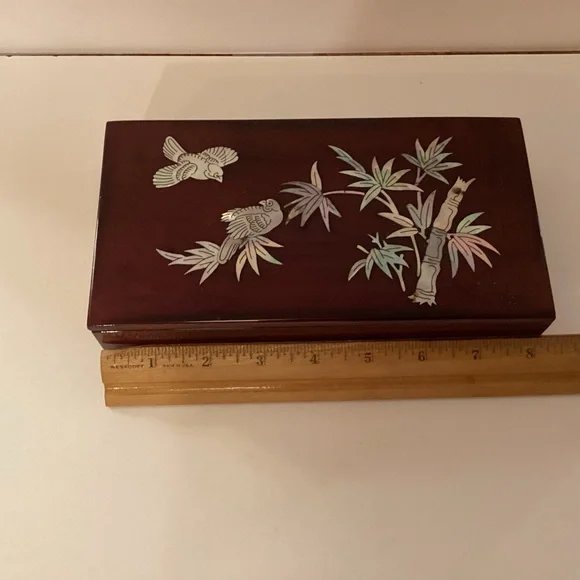 Vintage lacquered smoking box with mother of pearl inlay.